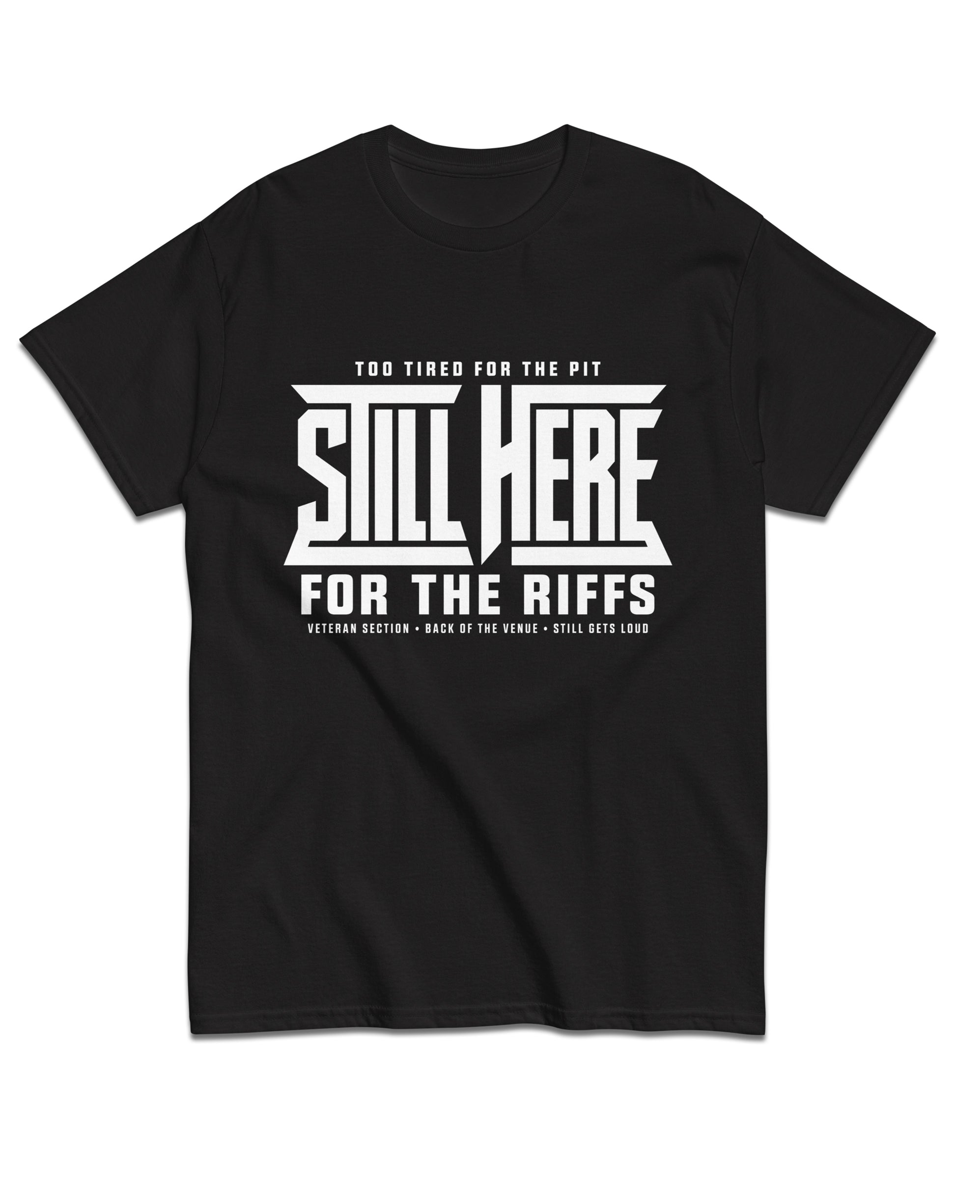A black short-sleeve crewneck t-shirt with a bold white graphic print on the front reading 'STILL HERE FOR THE RIFFS' with smaller text above and below, displayed on a solid white background.